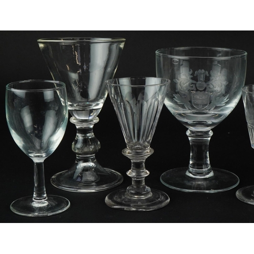 1323 - Eight antique and later wine glasses including a rummer with edged heraldic crest, the largest 15cm ... 