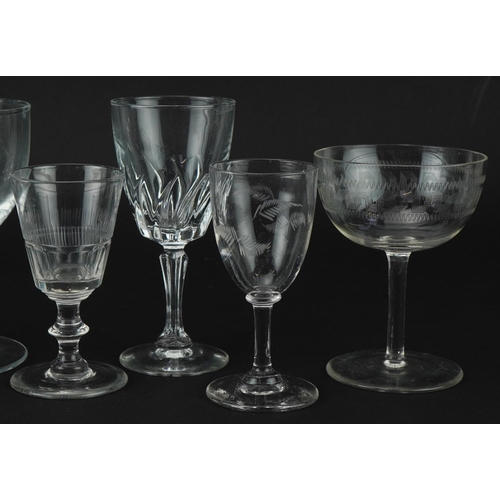 1323 - Eight antique and later wine glasses including a rummer with edged heraldic crest, the largest 15cm ... 