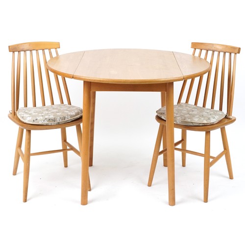 1108 - Ercol style lightwood drop end dining table with two stick back chairs, the table 74cm H x 55cm W x ... 