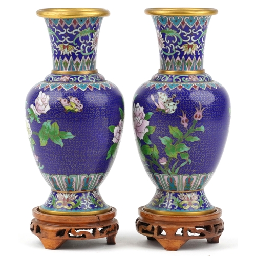 1490 - Pair of Chinese cloisonne vases raised on hardwood stands, each enamelled with butterflies amongst f... 