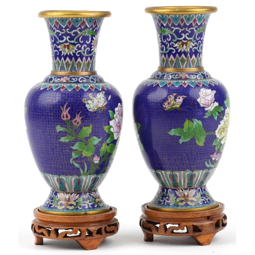 1490 - Pair of Chinese cloisonne vases raised on hardwood stands, each enamelled with butterflies amongst f... 