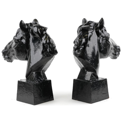 307 - Pair of classical black painted cast iron horseheads on tapering square bases, each 61.5cm high