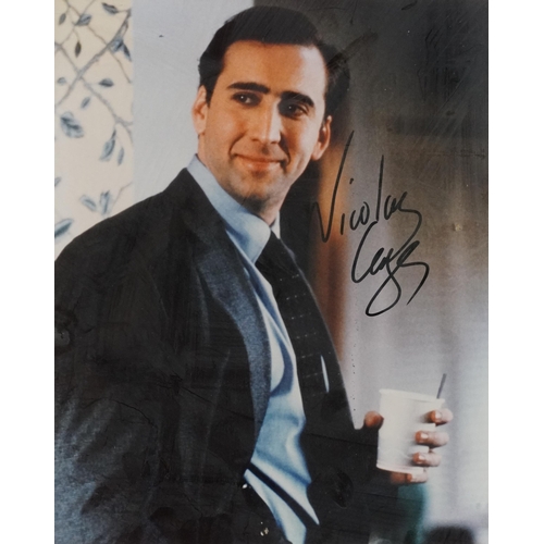 687 - Film interest coloured photograph of Nicholas Cage signed in ink with certificate of authenticity, m... 