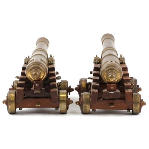 290 - Pair of mid 20th century bronze and hardwood model table cannons, each 22cm in length
PROVENANCE: Ma... 