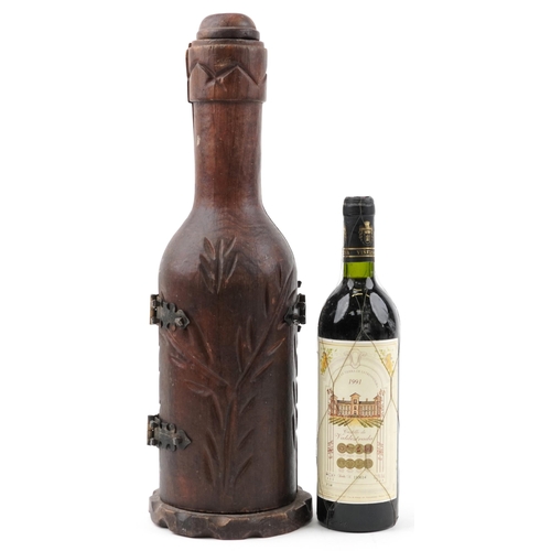 1205 - Carved hardwood bottle design bottle holder housing a bottle of 1991 Castillo de Valdestrada red win... 