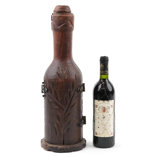 1205 - Carved hardwood bottle design bottle holder housing a bottle of 1991 Castillo de Valdestrada red win... 