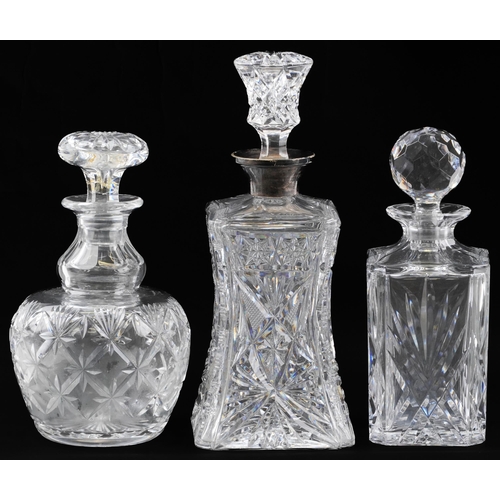 89 - Three cut glass decanters including an example with waisted body having silver collar, London 1930, ... 