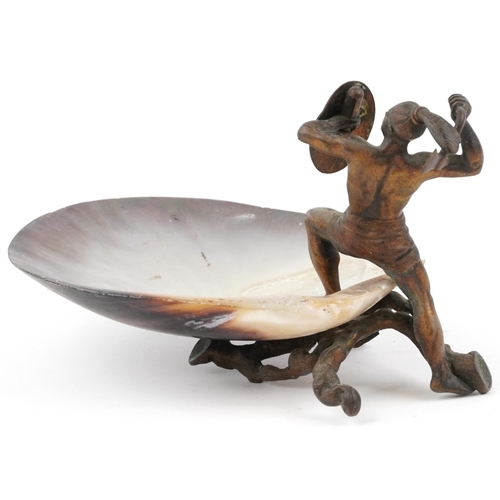 24 - 19th century gilt cast metal figure of a Mohawk warrior mounted on a mother of pearl dish, 20.5cm wi... 