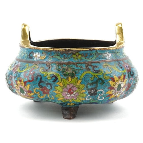 180 - Chinese patinated bronze tripod censer with twin handles enamelled with flowers amongst scrolling fo... 