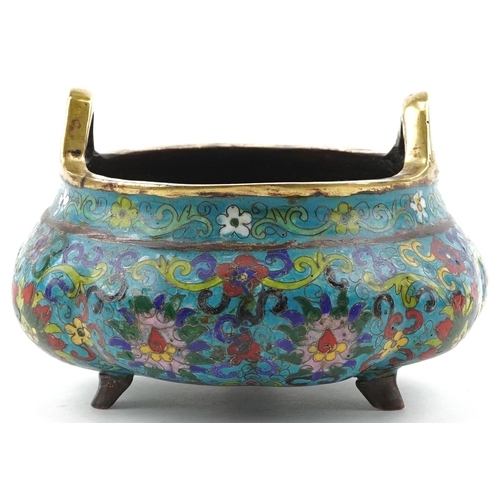 180 - Chinese patinated bronze tripod censer with twin handles enamelled with flowers amongst scrolling fo... 