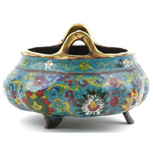 180 - Chinese patinated bronze tripod censer with twin handles enamelled with flowers amongst scrolling fo... 