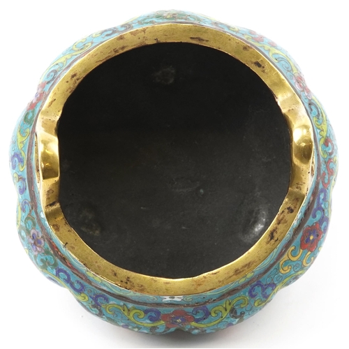 180 - Chinese patinated bronze tripod censer with twin handles enamelled with flowers amongst scrolling fo... 