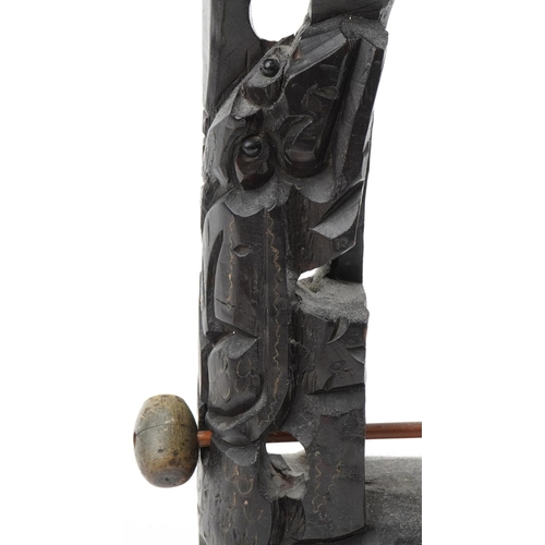 189 - Chinese bronze dragon bell mounted on a carved hardwood stand with metal inlay, 44cm high