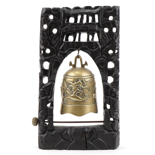 189 - Chinese bronze dragon bell mounted on a carved hardwood stand with metal inlay, 44cm high