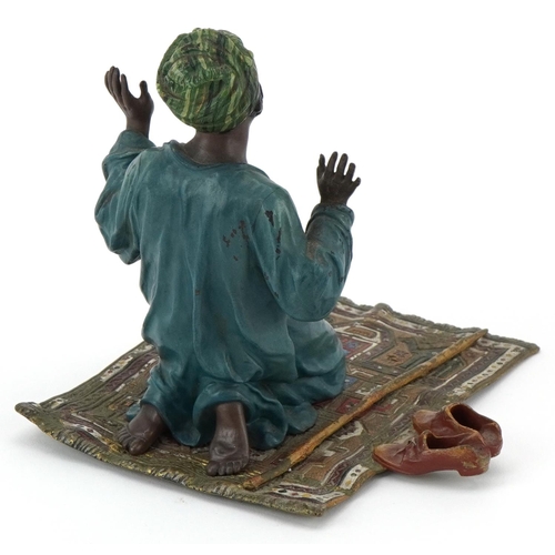 22 - Cold painted bronze figure of an praying Arab gentleman on a carpet, 13cm high