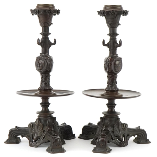 19 - Pair of Victorian Neo-Classical bronze candlesticks decorated with portraits and flowers, 23cm high