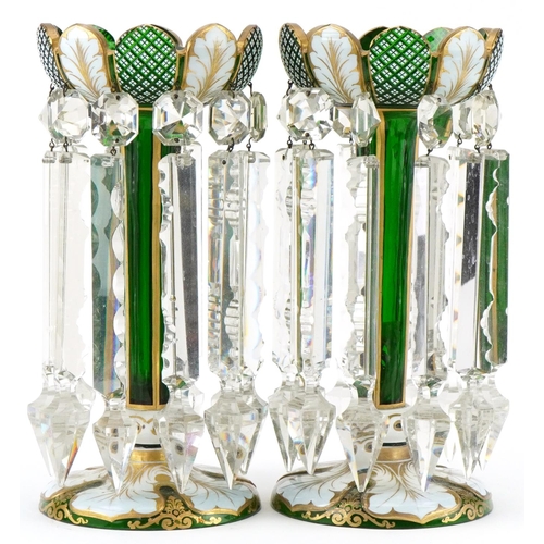 Pair of Victorian overlaid green glass lustres hand painted with leaves, having clear glass drops, each 29cm high