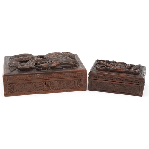 200 - Two oriental hardwood boxes carved with dragons, the largest 7cm H x 28cm W x 17cm D