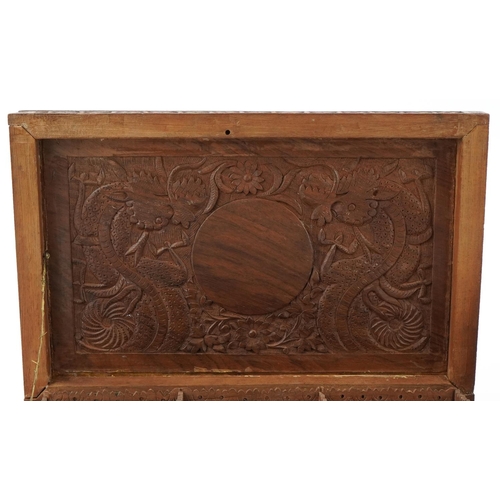 200 - Two oriental hardwood boxes carved with dragons, the largest 7cm H x 28cm W x 17cm D