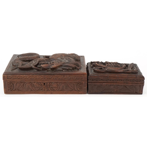 200 - Two oriental hardwood boxes carved with dragons, the largest 7cm H x 28cm W x 17cm D