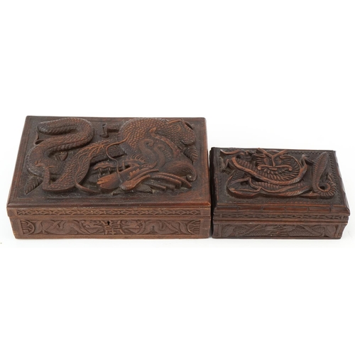 200 - Two oriental hardwood boxes carved with dragons, the largest 7cm H x 28cm W x 17cm D