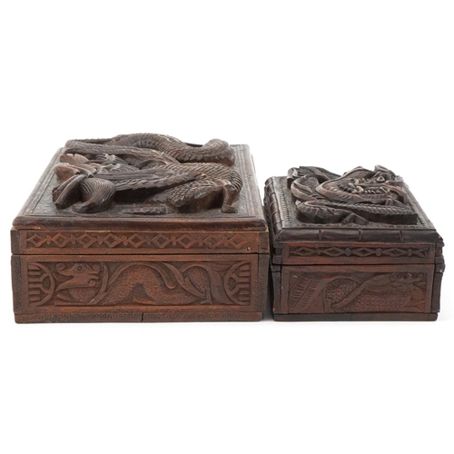 200 - Two oriental hardwood boxes carved with dragons, the largest 7cm H x 28cm W x 17cm D