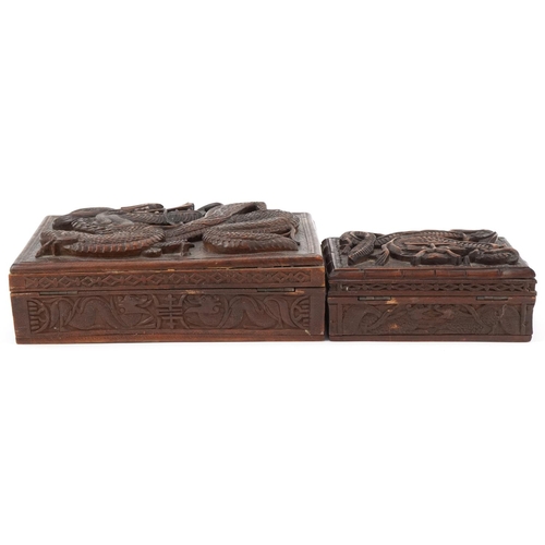 200 - Two oriental hardwood boxes carved with dragons, the largest 7cm H x 28cm W x 17cm D