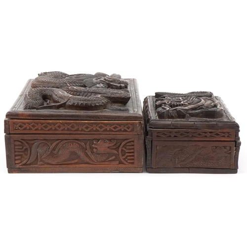 200 - Two oriental hardwood boxes carved with dragons, the largest 7cm H x 28cm W x 17cm D