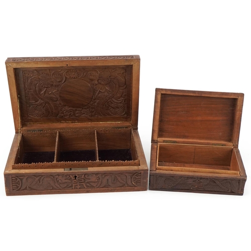 200 - Two oriental hardwood boxes carved with dragons, the largest 7cm H x 28cm W x 17cm D