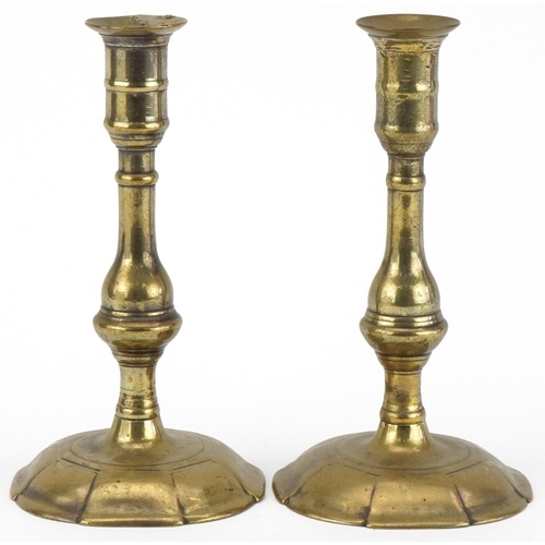 298 - Pair of Georgian brass petal based candlesticks, 19cm high