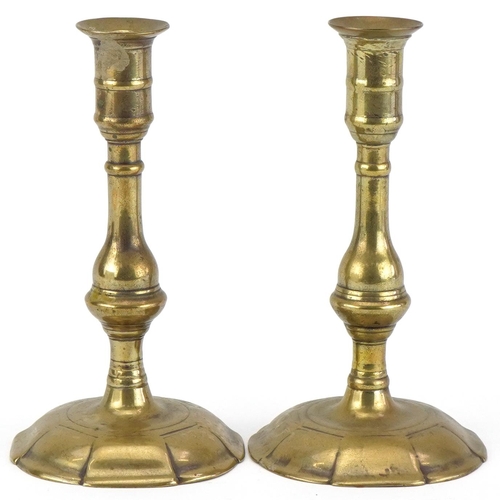 298 - Pair of Georgian brass petal based candlesticks, 19cm high