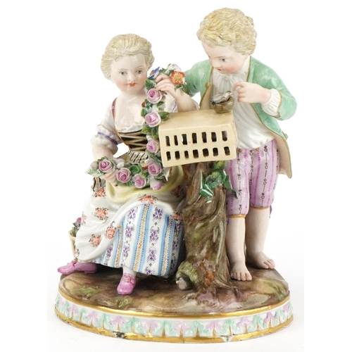 63 - Hand painted Meissen porcelain figure group of a boy, girl with bird cage, blue crossed swords mark ... 