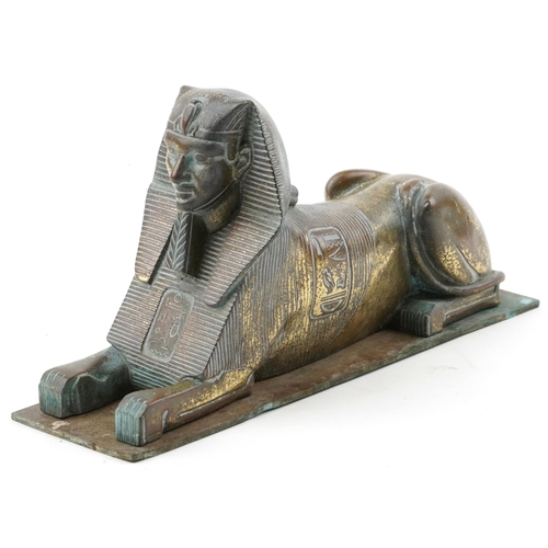 386 - Bronze model of a sphinx, 26cm in length