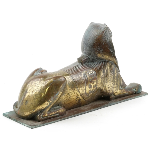 386 - Bronze model of a sphinx, 26cm in length