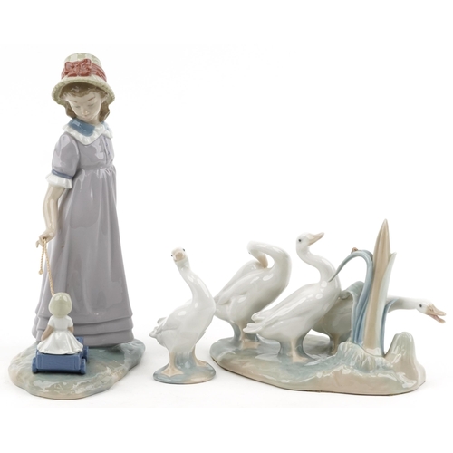 1159 - Lladro model of a girl with her doll in a cart together with a model of geese and a single goose, th... 