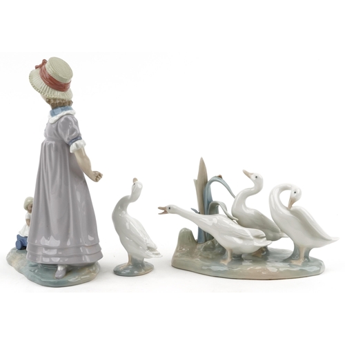 1159 - Lladro model of a girl with her doll in a cart together with a model of geese and a single goose, th... 