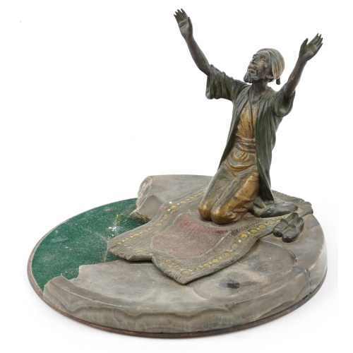23 - Cold painted bronze and spelter figure of an Arab gentleman praying, 24cm wide