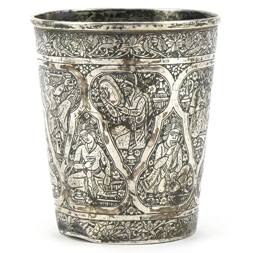 379 - Islamic silver beaker profusely engraved with figures, impressed marks to the base,  8cm high, 84.2g