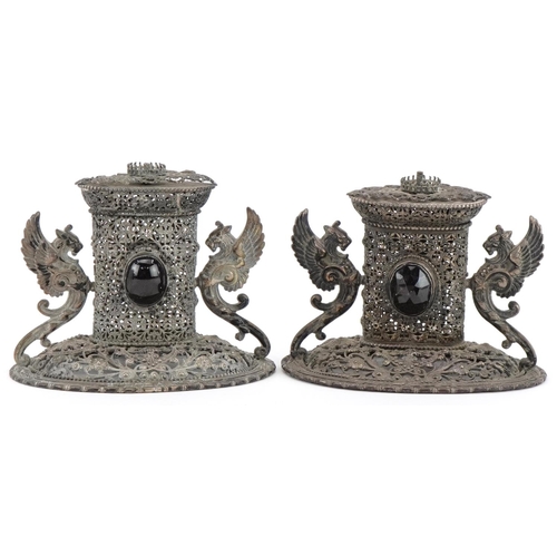 322 - Two of European white metal filigree ornaments with winged dragon handles set with black cabochons, ... 