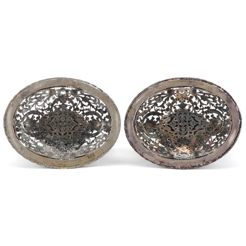 322 - Two of European white metal filigree ornaments with winged dragon handles set with black cabochons, ... 