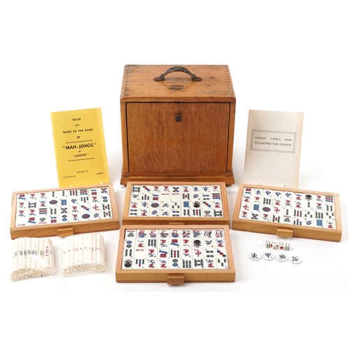 1529 - H P G & S Ltd Chinese mahjong set by Jackpot with instructions, housed in a light oak five drawer ch... 