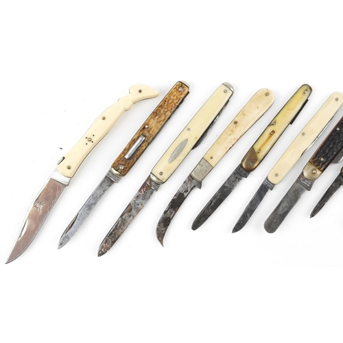 330 - Eleven knives folding pocket knives, some with bone handles