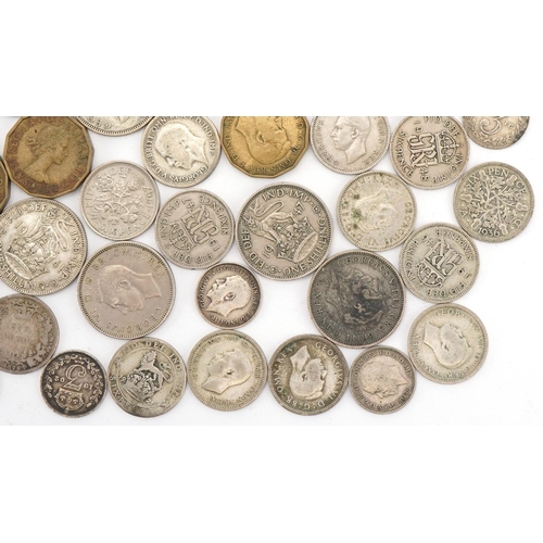 619 - Assorted silver and later coinage including sixpences and threepenny pieces, George V and later