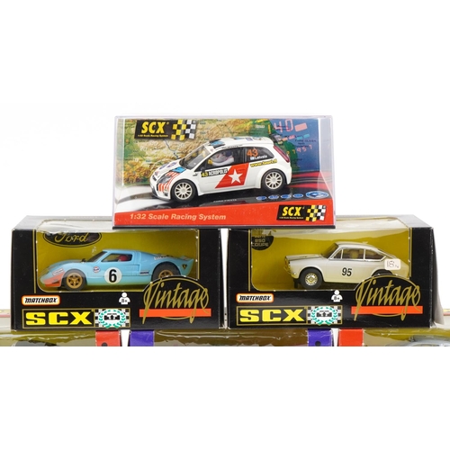 1594 - Ten Matchbox SCX 1:32 scale model slot cars with boxes and cases including Subaru Impreza, Porsche 9... 