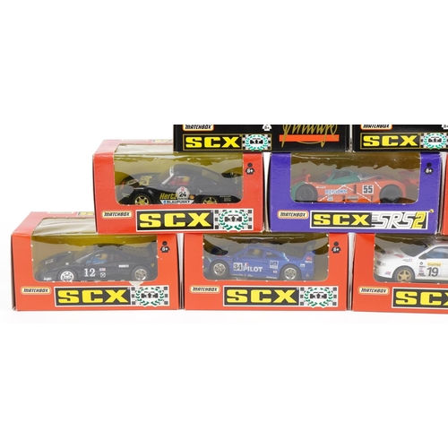 1594 - Ten Matchbox SCX 1:32 scale model slot cars with boxes and cases including Subaru Impreza, Porsche 9... 