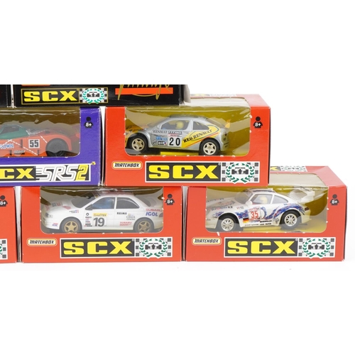 1594 - Ten Matchbox SCX 1:32 scale model slot cars with boxes and cases including Subaru Impreza, Porsche 9... 