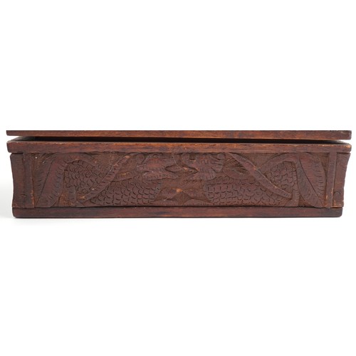 200 - Two oriental hardwood boxes carved with dragons, the largest 7cm H x 28cm W x 17cm D