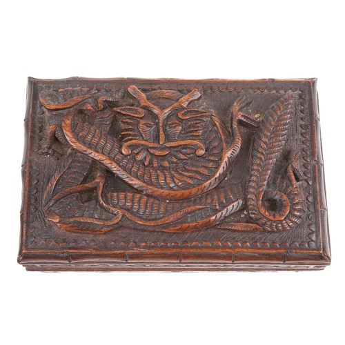 200 - Two oriental hardwood boxes carved with dragons, the largest 7cm H x 28cm W x 17cm D