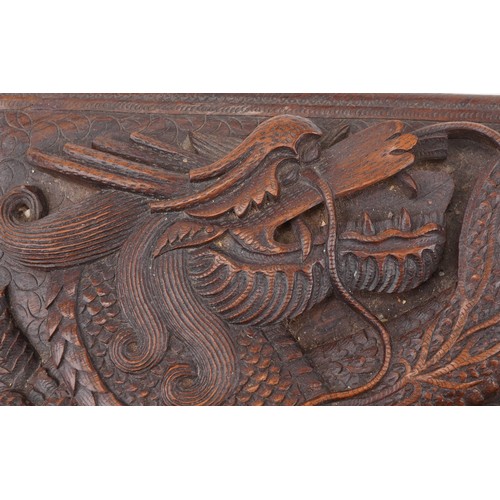 200 - Two oriental hardwood boxes carved with dragons, the largest 7cm H x 28cm W x 17cm D