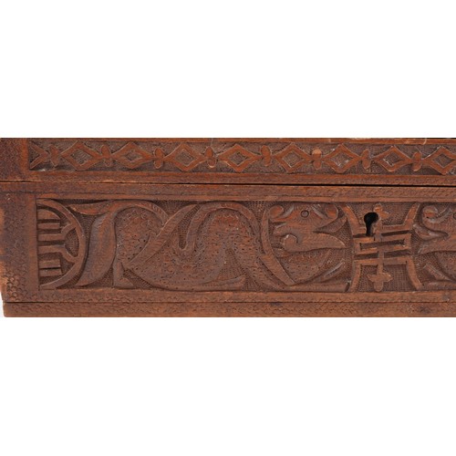 200 - Two oriental hardwood boxes carved with dragons, the largest 7cm H x 28cm W x 17cm D